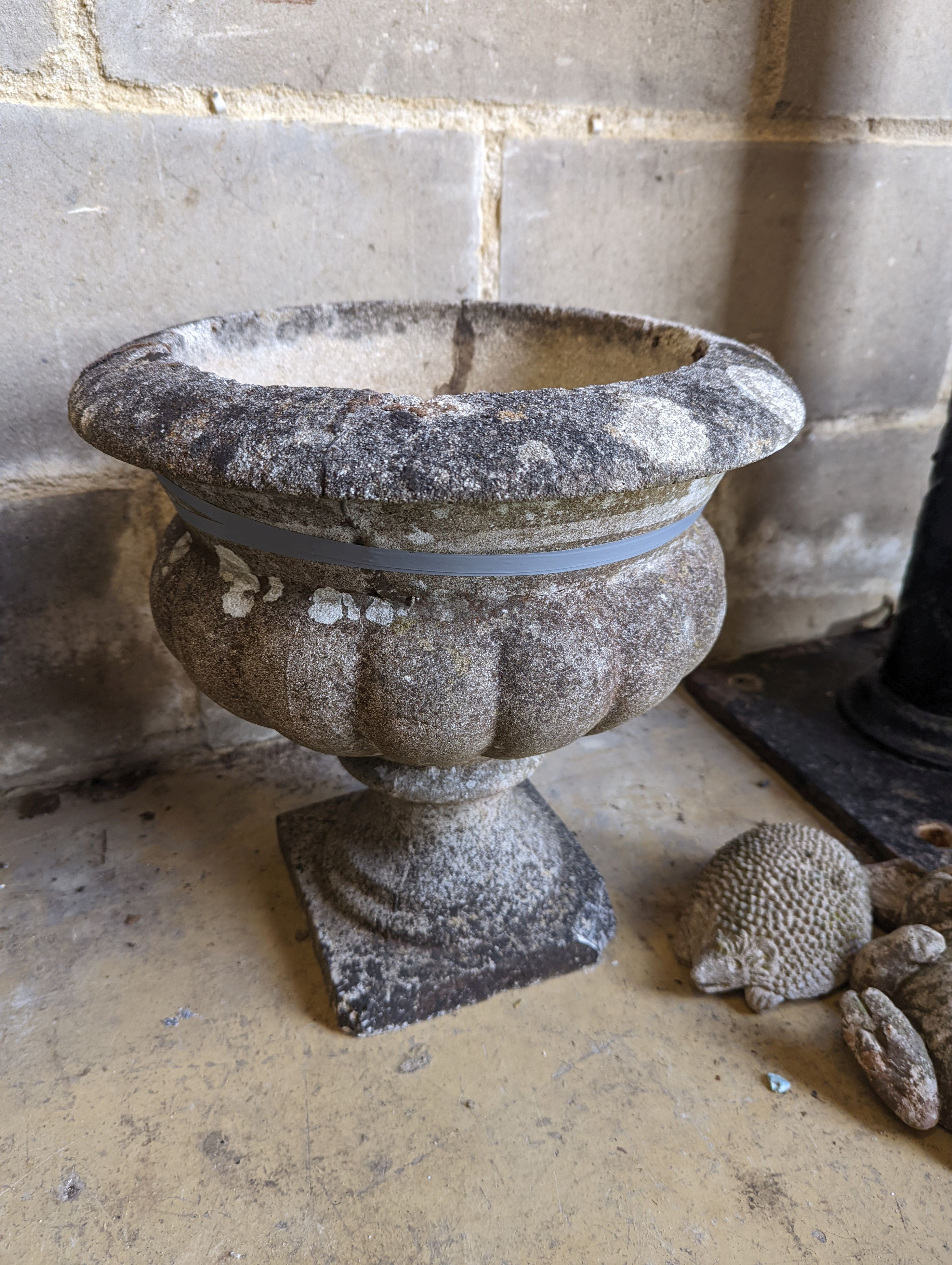 A pair of reconstituted stone circular campana garden urns, diameter 34cm, height 36cm